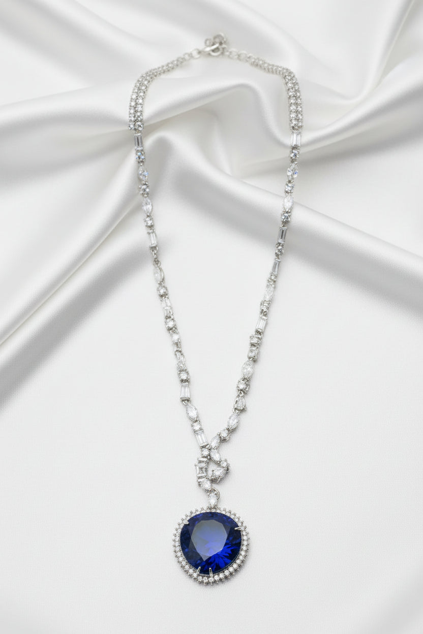 Necklace with a blue pendant on a dark fabric background