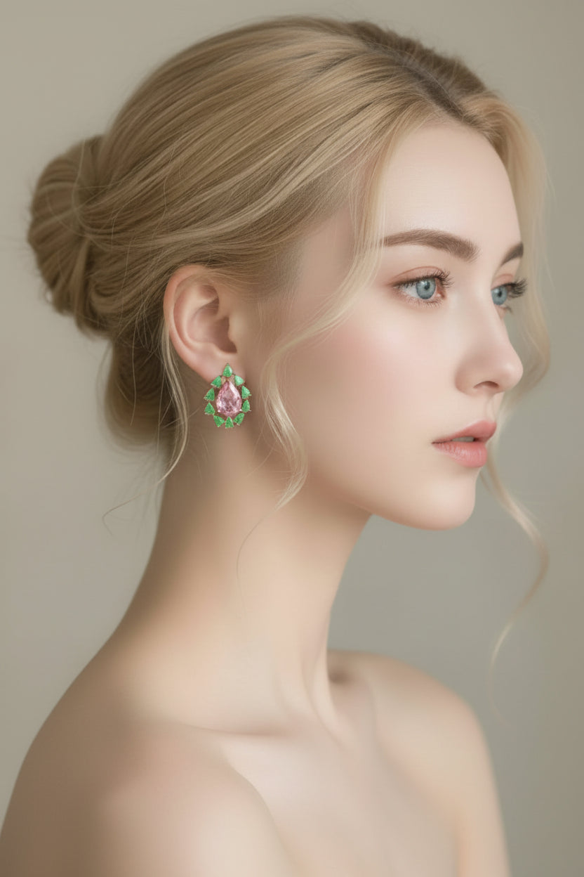 Woman wearing a green gemstone earring against a neutral background