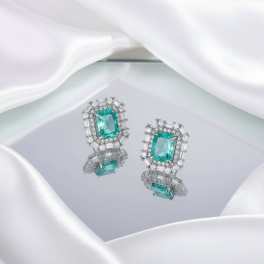 Pair of earrings with green gemstones and silver frame