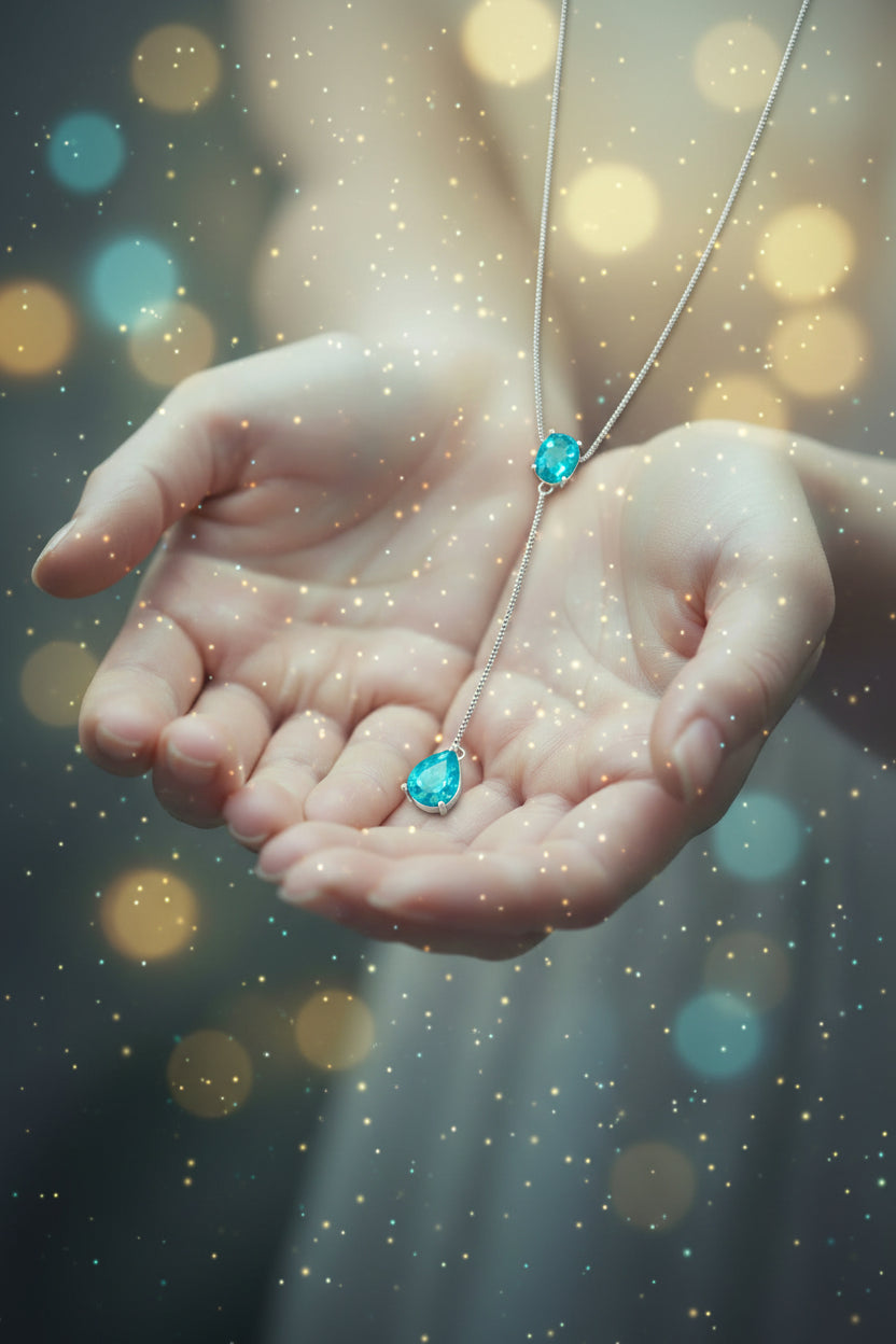 Necklace with blue gemstones held in hands against a blurred background