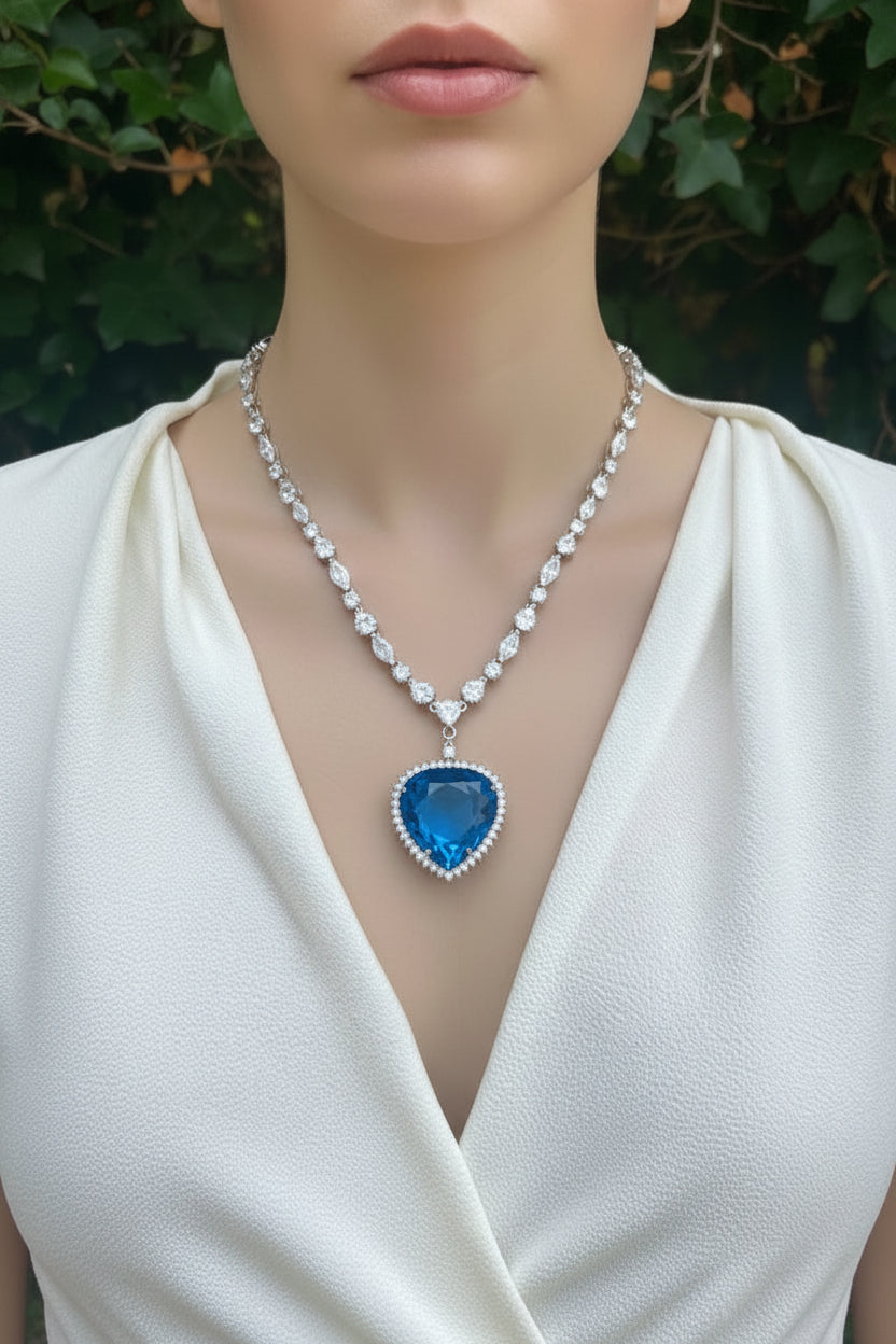 Necklace with a blue pendant on a mannequin wearing a white top.
