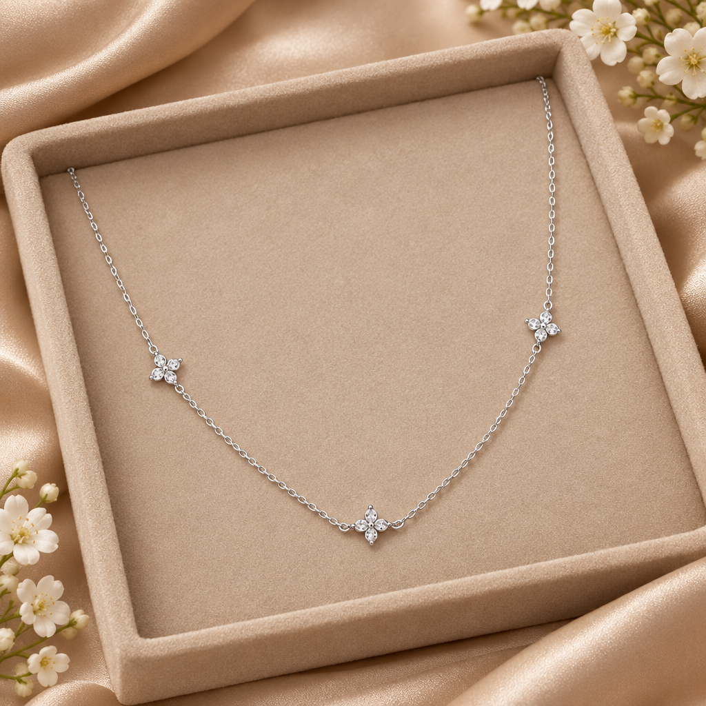 Silver-tone zircon flower necklace in a nude tray with satin and discreet flowers